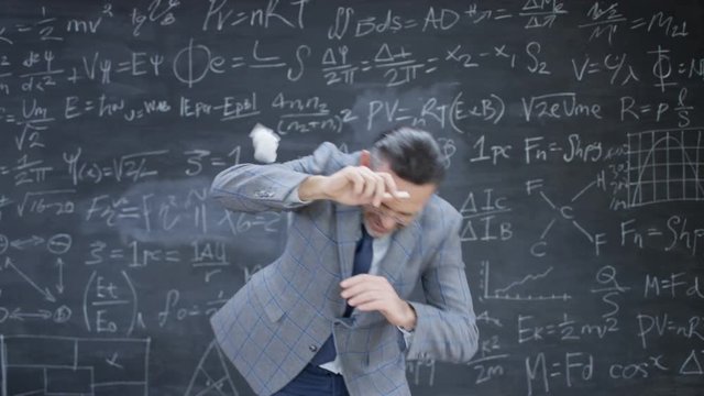  Teacher in classroom has balls of paper thrown at him by unruly students