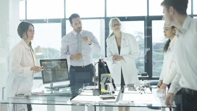  Scientific research engineers working in lab with computer & 3D printer