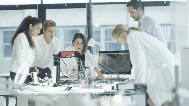  Scientific research engineers working in lab with computer & 3D printer