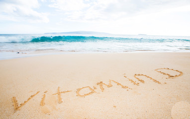 Fototapeta na wymiar Vitamin D written in the sand at a tropical beach