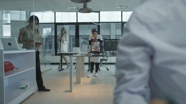  Scientific research engineers working in lab with man building robotic arm