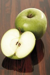 Green apples on a wooden table