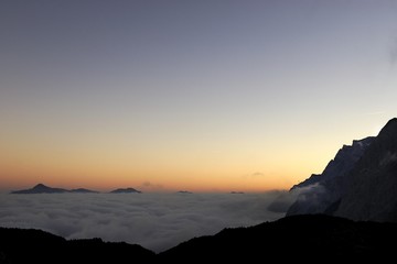 Sun rising over a sea of clouds, Mt. Zugspitze, Ehrwald, Tirol, Austria, Europe