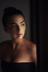 Pretty young woman looking out the window