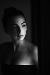 Pretty young woman looking out the window