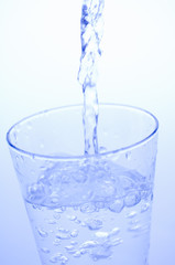 Pouring mineral water into a glass