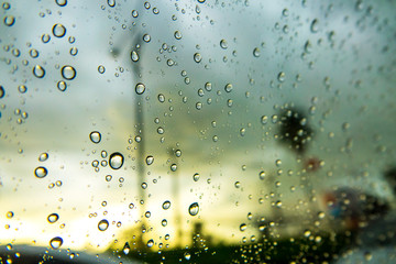 Raindrops on the window before the sunset. Rain drops on glass.