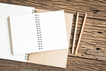 Top view notebook on rough wooden texture. Concept for education and business. Office top view background.