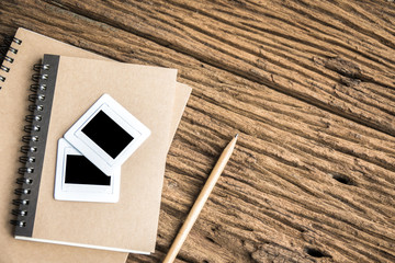 Top view film slide with notebooks on rough wooden background. Film slide 35 mm.