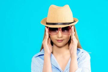 Young Asian woman thinking isolated on blue background.