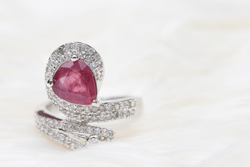 pink gemstone on diamond ring