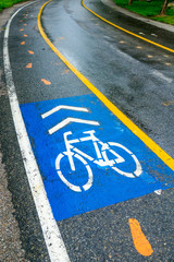 Bicycle sign on road in the park