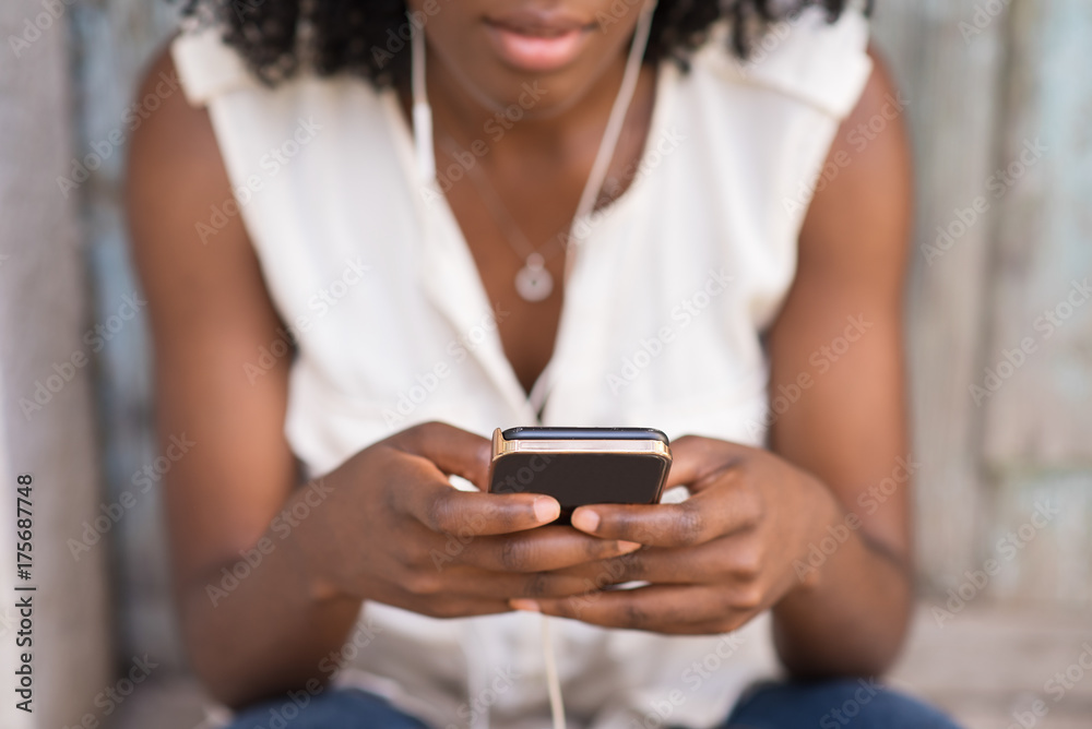 Wall mural close-up of female hands using smartphone outdoors