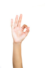 Female hand gesture making "OK" sign on white background.