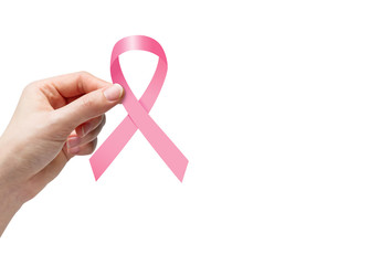Woman hand holding pink ribbon for breast cancer awareness on white background