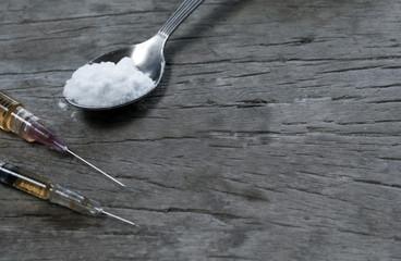 Drugs syringe and cooked heroin on spoon - obrazy, fototapety, plakaty