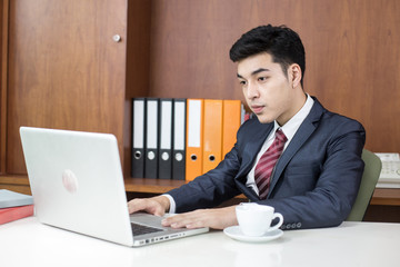 Asian Young Businessman working at office, Businessman using Laptop for work, People working concept.