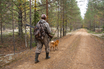 hunter walking on the forest road