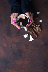 Woman holding cup of hot chocolate.