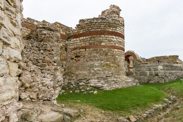 The watchtower and the fortress wall at the entrance of the old town of Nesebar. Nesebar is an...