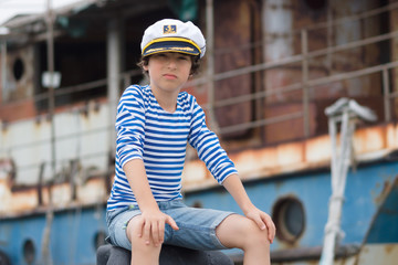 Portrait of a boy in a vest (Telnyashka) and captain's cap.