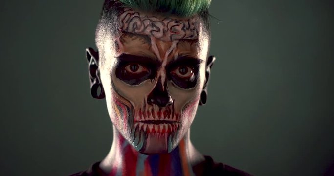 Footage of man with colored zombie makeup. Dead mask skull for Halloween party.