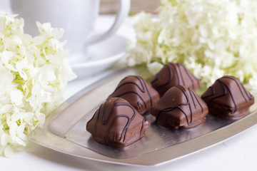 Chocolate sweets on a silver tray. Dessert for breakfast