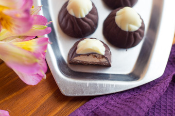 Chocolate sweets on a silver tray. Dessert for breakfast
