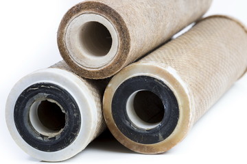 Dirty water filter cartridges on white background
