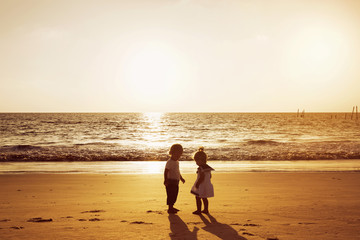 Little boy girl beach sunset sea