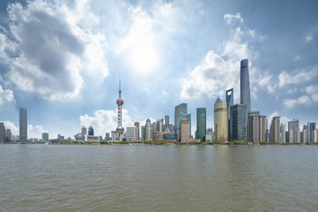 Fototapeta na wymiar panoramic view of shanghai skyline with huangpu river under blue sky