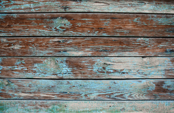 Old shabby wooden background with cracks and layers of paint