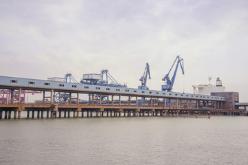 Ship unloader and conveyer belt at port terminal