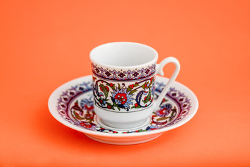 Classic Porcelain Turkish Coffee Cup on Orange Background