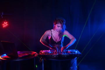 Pretty Asian female woman DJ playing music for dance.