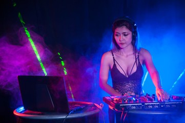 Fototapeta na wymiar Pretty Asian female woman DJ playing music for dance.