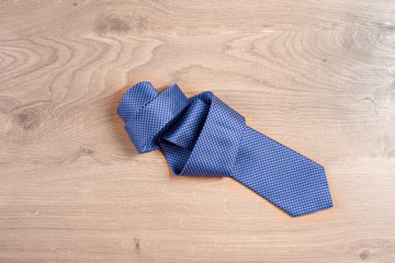 Men's accessories men's tie on a wooden background. Classic men's accessories. Top view