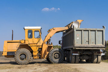 truck loader loads land in a truck