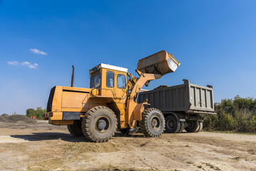truck loader loads land in a truck