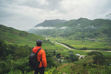 Young traveler standing and looking at view of nature