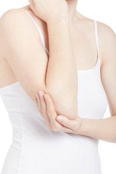Young woman with white shirt holding arm and elbow in pain isolated on white, clipping path