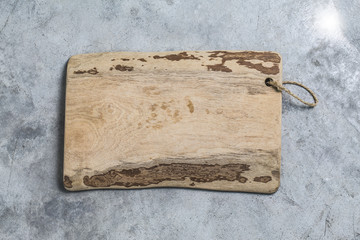Fototapeta premium Cutting board on the cement background. Top view.