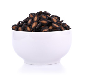 watermelon seeds in bowl isolated on white background
