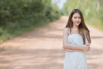 Portrait of a young beautiful  fashionable woman keeping arms crossed and looking at camera  with smile .