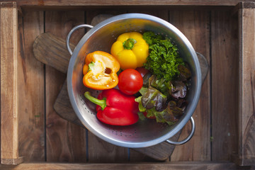 vegetables in the bowl. wooden background.