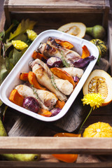 pumpkin baked with chicken. autumn vegetables. tray with food.