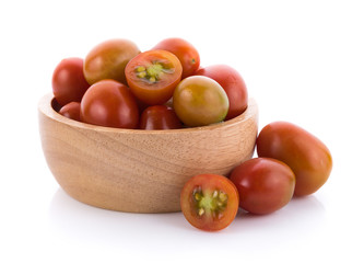 tomato in wooden bowl on white background