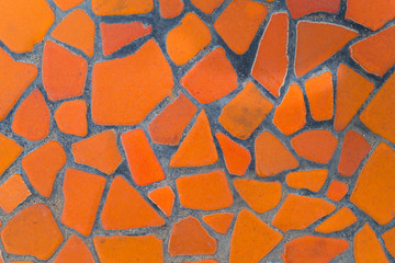 Texture of orange tile floor on cement walkway. The front walkway is built of inexpensive cement in the garden. Close up orange rock surface, ideas for house and garden design. - Background abstract.