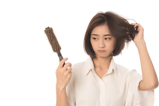 Portrait  of asian woman long hair with a comb and problem hair on white background, Free form copy space.This image for hair loss concept.