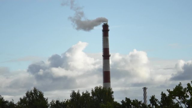 Moving clouds Power Plant pipe with smoke Latvia 4K